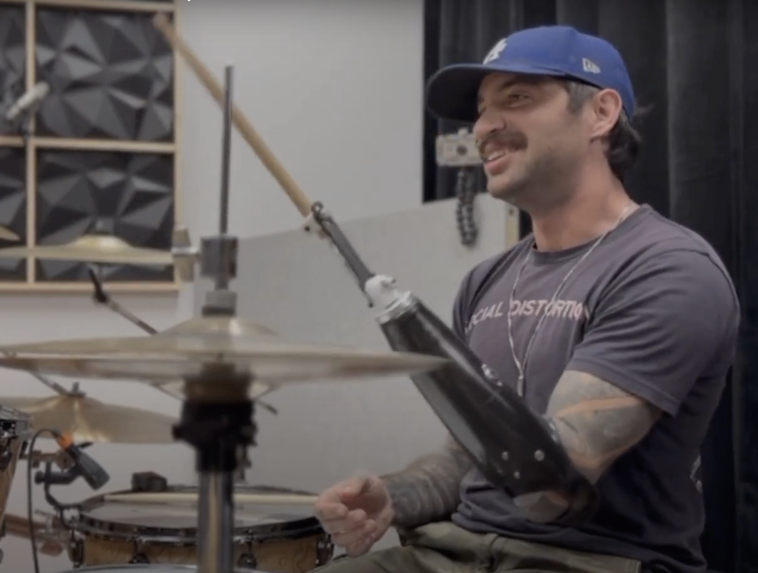 Josh playing drums with his adaptive drumming prosthetic